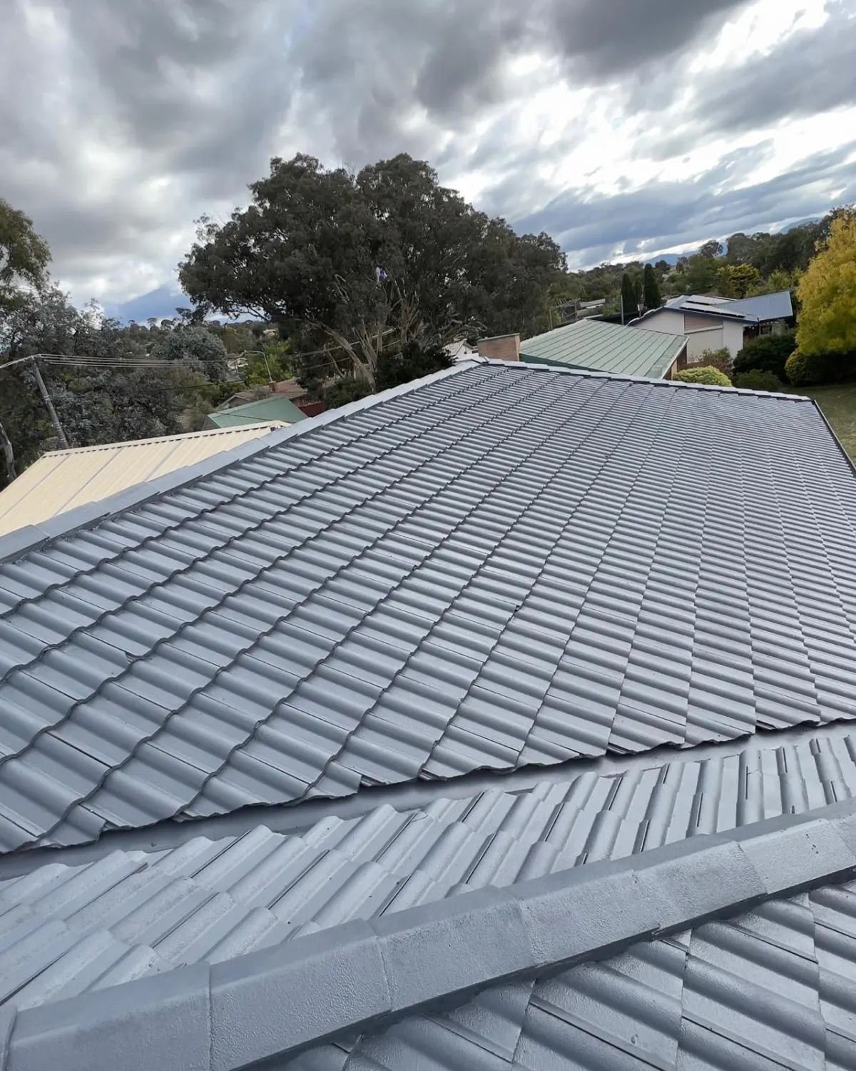 Restored and freshly coated tiled roof on a Canberra home by Blue Painting & Decorating